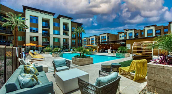 Elevation SanTan swimming pool with lounge chairs and tables in front