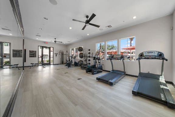 A spacious gym with treadmills and other exercise equipment.