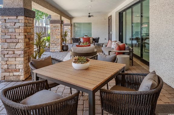 A patio with a table and chairs.