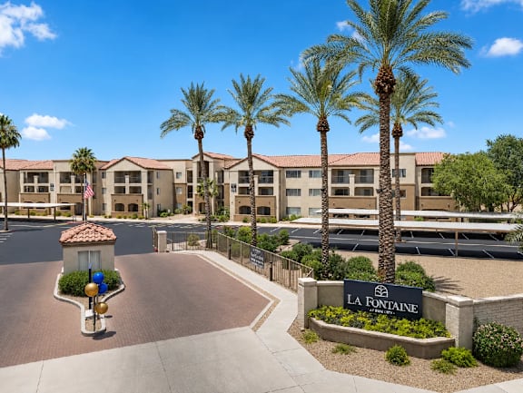 A sunny day at La Fontaine apartment complex with palm trees and a clear blue sky.