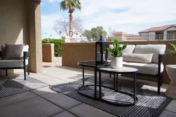 A patio with a table and chairs.