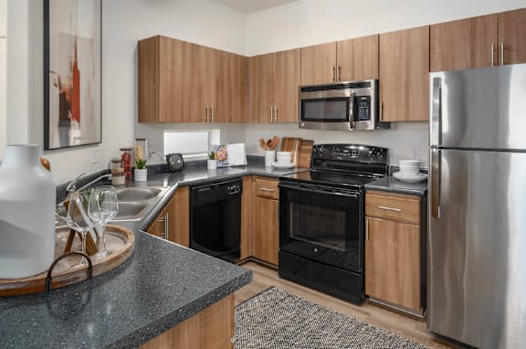 A modern kitchen with wooden cabinets and stainless steel appliances.