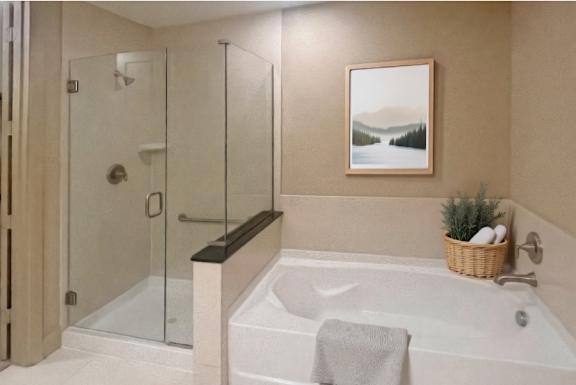 Luxury bathroom with granite countertops, glass shower and separate soaking tub at Villa Piana Apartments in Dallas