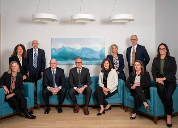 A group of executives standing together for a group picture