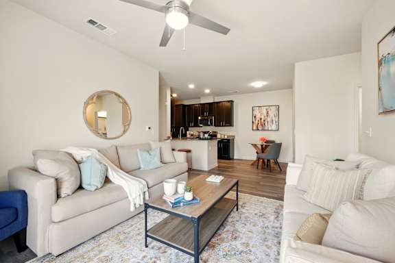 A living room with a white couch and a coffee table.
