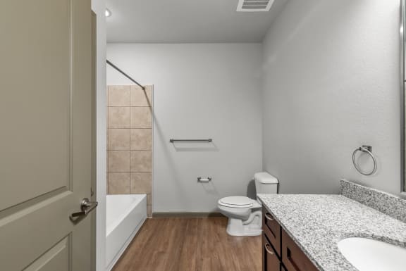 a bathroom with a toilet and a shower and a sink