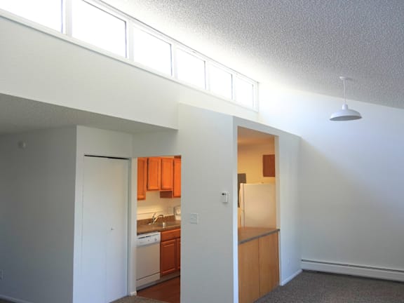 A kitchen with orange cabinets and a white refrigerator.