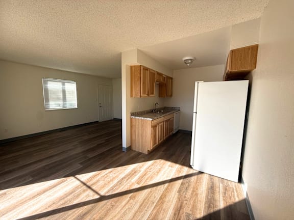 A kitchen with wooden floors and white walls. at Willow Grove Apartments , Clifton, CO