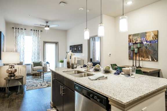 A kitchen with a large island and a dishwasher.