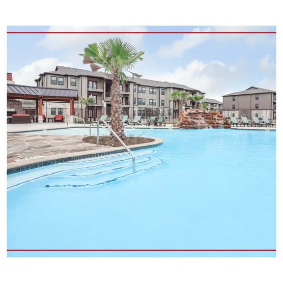 a large swimming pool with a palm tree in the middle of it  at Valor at Harlingen, Texas