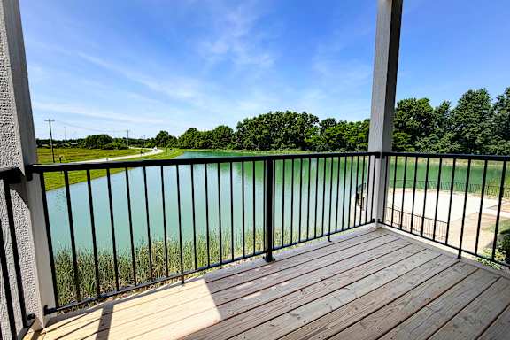 Balcony overlooking pond with black metal railing at The Meridian on 32 Apartments, Batavia, Ohio