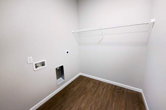 Walk-in closet with wire shelf and washer dryer connections at The Meridian on 32 Apartments, Batavia, OH