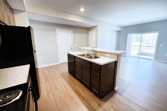 an empty kitchen and living room with wood flooring and  at Brookfield Village Apartments, Ohio