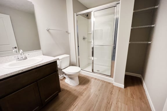 an empty bathroom with a shower toilet and sink