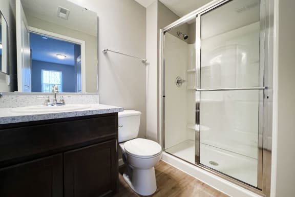 a bathroom with a shower and a sink and a toilet  at Brookfield Village Apartments, Ohio, 43123