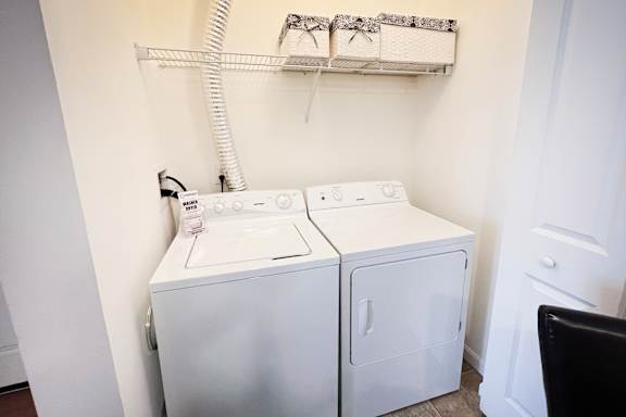 a white washer and dryer in a white laundry room