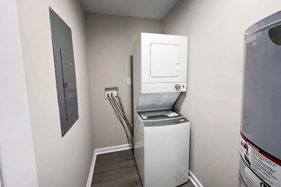A white washing machine in a small laundry room.