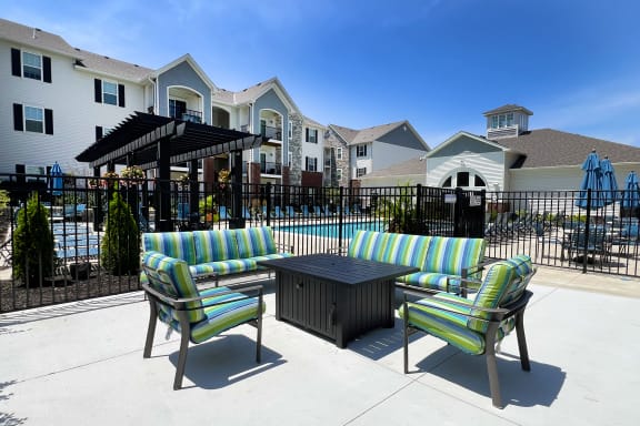 our apartments have a large patio with furniture and a pool