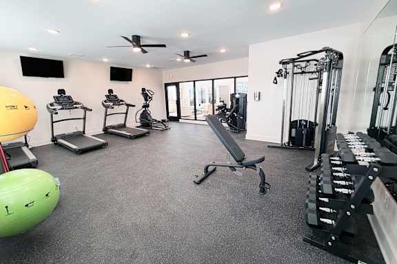 Fitness center with treadmills and weight machines at The Meridian on 32 Apartments, Batavia, Ohio