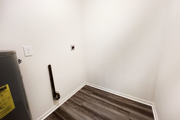 an empty room with a white wall and wooden floors at Four Worlds Apartments, Cincinnati, 45231