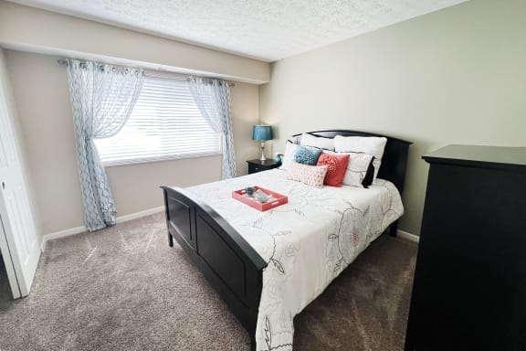 an empty bedroom with a bed and a window  at Fox Run Apartments, Cincinnati, OH, 45236