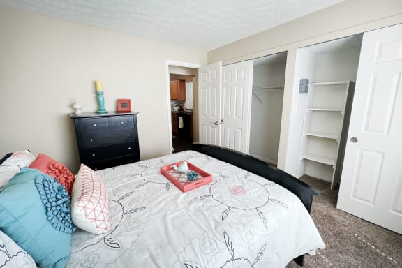 a bedroom with a bed and a closet  at Fox Run Apartments, Cincinnati, OH, 45236