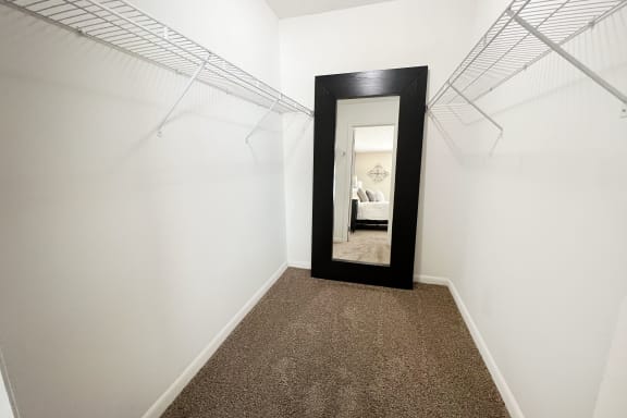 a hallway with a mirror and white walls and carpet  at Fox Run Apartments, Cincinnati, OH, 45236