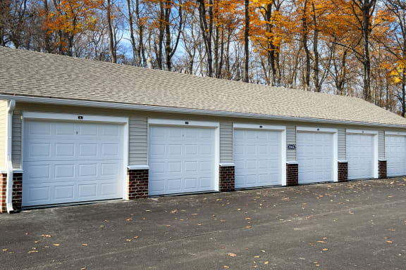 a row of garages with white garage doors  at Brookfield Village Apartments, Grove City