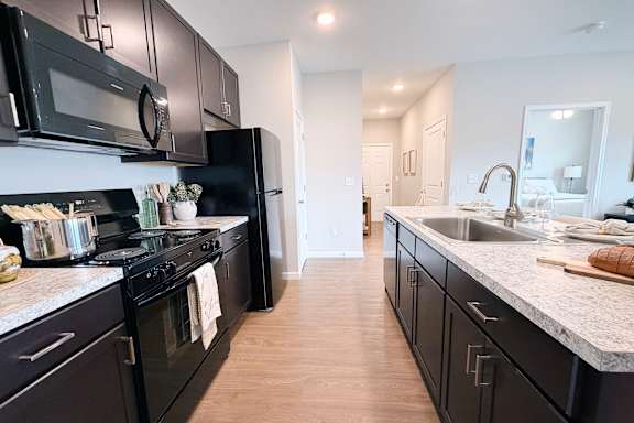 Galley kitchen with stainless steel appliances and granite countertops at The Meridian on 32 Apartments, Batavia, OH 45103