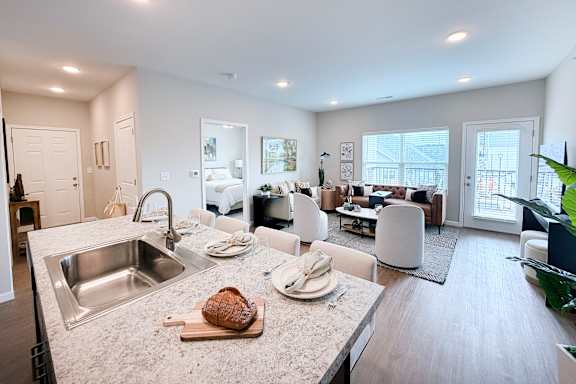 Open floor plan with kitchen island and living space at The Meridian on 32 Apartments, Batavia, 45103