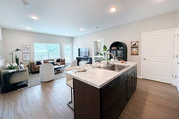 Open concept kitchen and living room with island at The Meridian on 32 Apartments, Batavia, Ohio