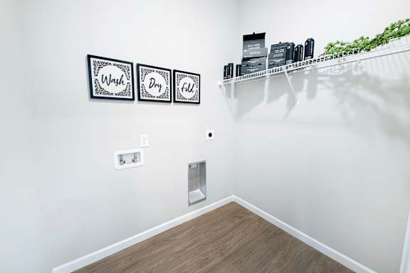 Laundry room with wash dry fold wall decor at The Meridian on 32 Apartments, Batavia