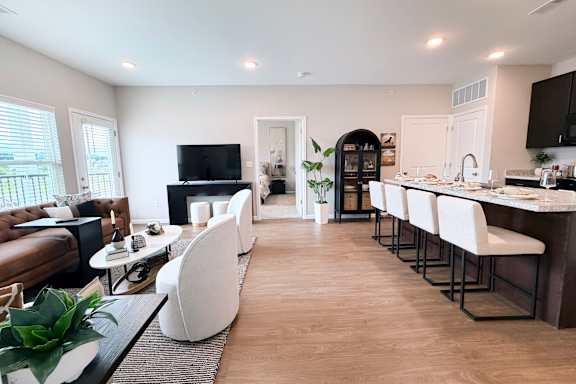 Open concept living space with kitchen island seating at The Meridian on 32 Apartments, Batavia, 45103