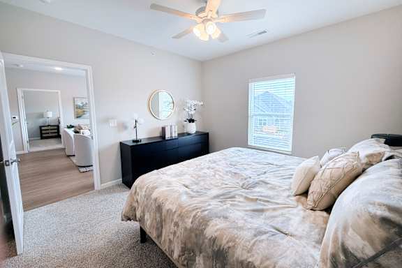 Spacious bedroom with ensuite bathroom access at The Meridian on 32 Apartments, Batavia, Ohio