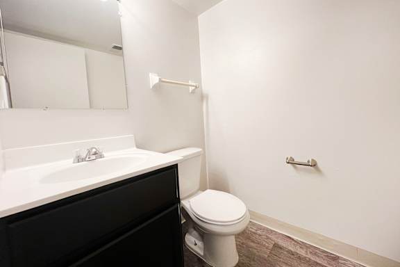 an empty bathroom with a toilet and a sink