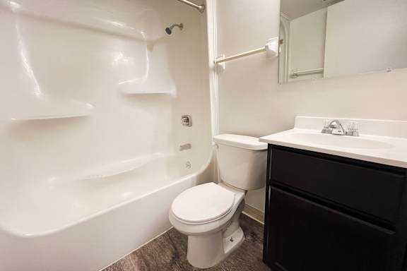 A white toilet sits next to a sink in a bathroom at Indian Lookout Apartments, Cincinnati, 45238