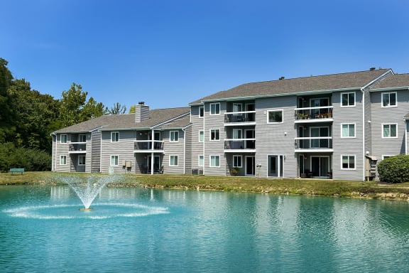 a fountain in a lake in front of an apartment building at Deercross Apartments, Cincinnati, 45236