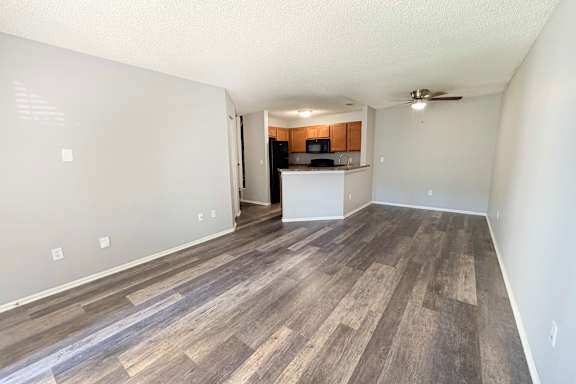 A room with wooden flooring and a ceiling fan.