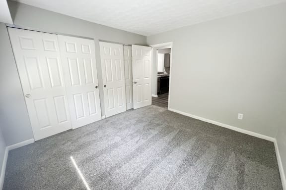 an empty bedroom with white doors and carpeting  at Fox Run Apartments, Cincinnati, OH, 45236