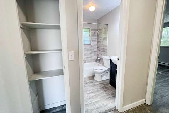 A bathroom with a walk-in shower and a toilet.