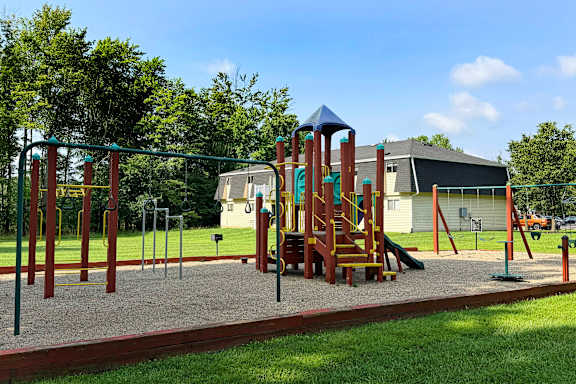 A playground with a swing set and a slide.
