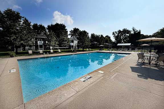 A large outdoor swimming pool with a sun lounger area.