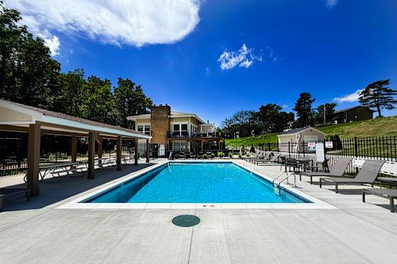 A large swimming pool with a building in the background.