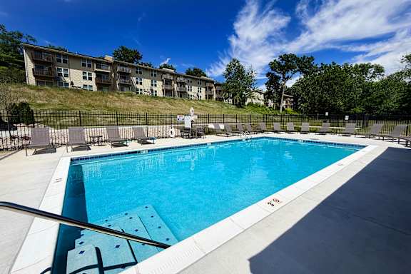 A large swimming pool with a metal railing around it.