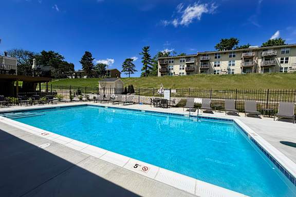 A large swimming pool with a 5 feet depth marking.