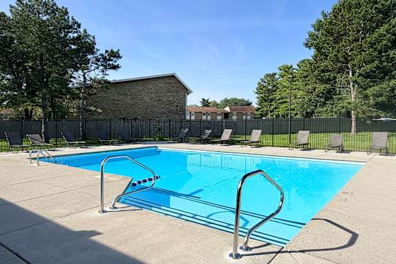 A small pool with a diving board in the foreground.