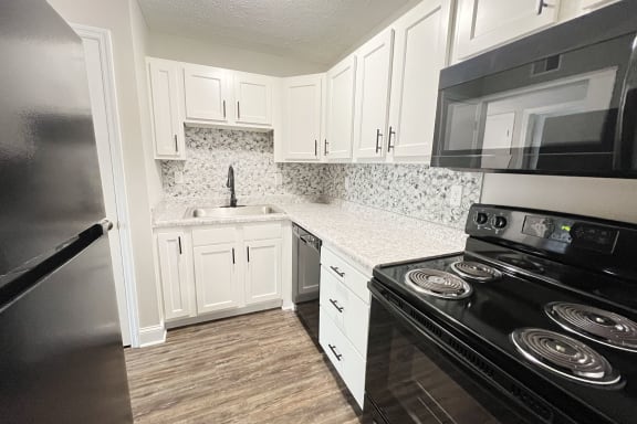 a kitchen with black appliances at 450 on Keeneland Apartments, Richmond
