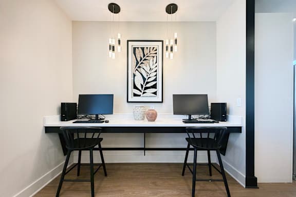 Dual workstation desk with computers and pendant lighting at The Meridian on 32 Apartments, Batavia, OH