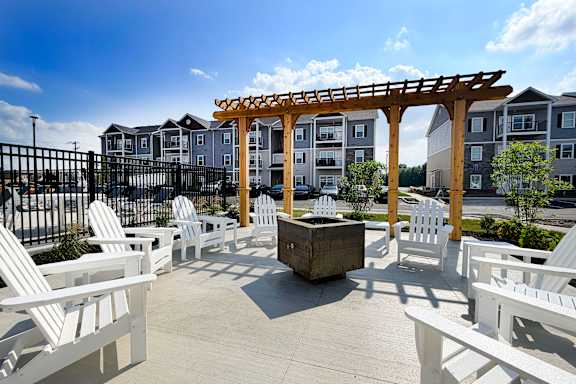 Poolside lounge seating with pergola and fire feature at The Meridian on 32 Apartments, Batavia