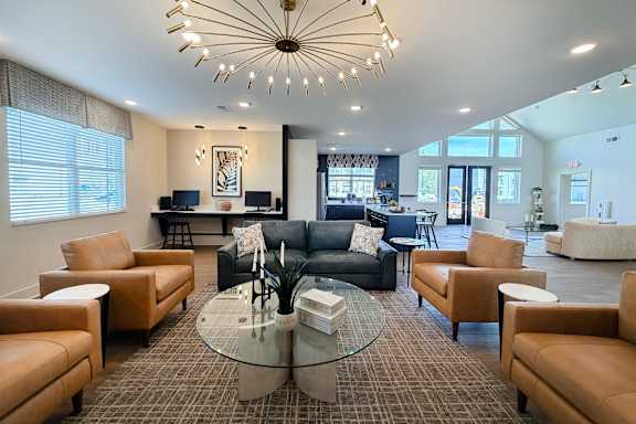 Resident lounge with starburst chandelier and leather seating at The Meridian on 32 Apartments, Batavia, 45103